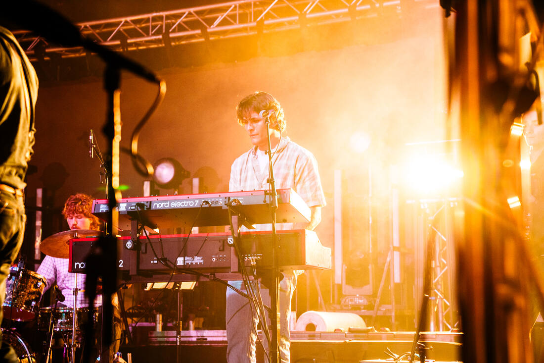 Garrett Summers on keys under warm stage lights